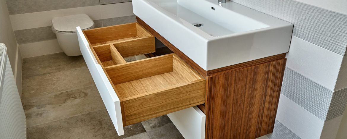 Bathroom console sink vanity in luxury bathroom with teak floor and striped tiles. Stylish interior of modern bathroom. Details furniture