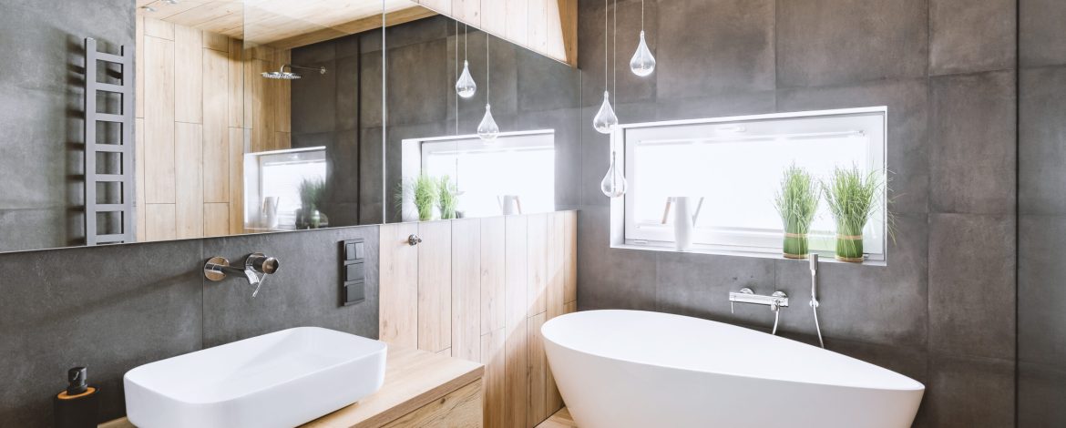 Stylish bathroom with wooden and concrete walls and white bath