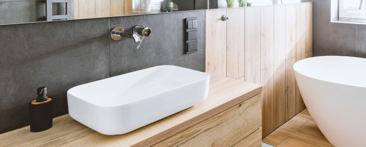 Stylish bathroom with wooden and concrete walls and white bath